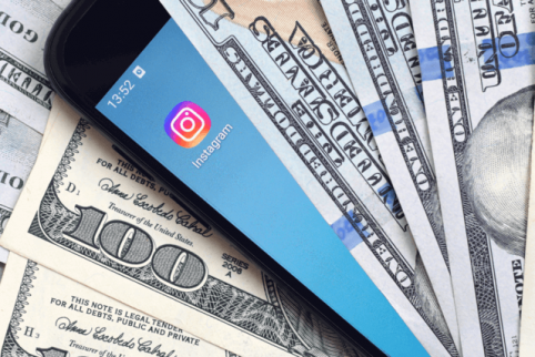 a phone between cash money that is worthy because of instagram.