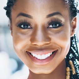 Young woman smiling satisfied with her results after getting Instagram followers and likes.
