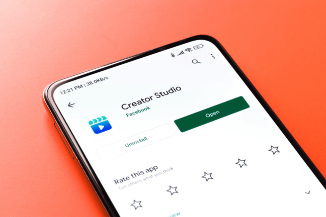 A phone used to download Facebook Creator Studio.